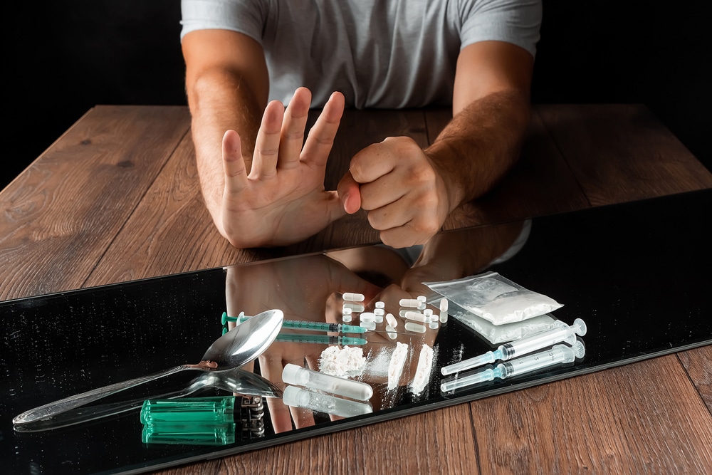 A man making a stop gesture to refuse drugs highlighting the need for professional help treatment options and understanding withdrawal symptoms